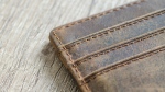 A wallet sits on a table in a stock image. (Lukas/Pexels.com)
