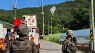 Balloons with trash hang on electric wires as South Korean army soldiers stand guard in Muju, South Korea on Wednesday, May 29, 2024. (Jeonbuk Fire Headquarters via AP)