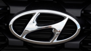 The Hyundai logo shines off the grille of an unsold vehicle at a Hyundai dealership, Sept. 12, 2021, in Littleton, Colo. (AP Photo/David Zalubowski, File)