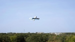 This photo provided by Amazon shows a drone delivering prescription drugs in College Station, Texas. (Amazon via AP)