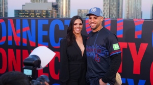 George Springer speaks to reporters at a release party for the Toronto Blue Jays’ City Connect jerseys on Thursday night alongside wife Charlise Castro. He told reporters the team first saw the design last year, when it was ‘in its infancy stage” and the reveal has been “a long time coming.” 