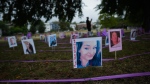 Photographs of overdose victims are displayed as members of Moms Stop the Harm mark International Overdose Awareness Day, in Vancouver, Thursday, Aug. 31, 2023. THE CANADIAN PRESS/Darryl Dyck