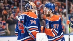 Edmonton Oilers goalie Stuart Skinner (74) and Connor McDavid (97) celebrate after defeating the Dallas Stars in game 4 of the Western Conference finals of the NHL Stanley Cup playoffs in Edmonton on Wednesday May 29, 2024. (Jason Franson / The Canadian Press) 