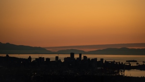 The downtown Vancouver skyline is silhouetted at sunset on Monday, July 11, 2022. THE CANADIAN PRESS/Darryl Dyck