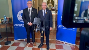 BC Conservative Leader John Rustad stands by MLA Lorne Doerkson during an announcement Friday that Doerkson is switching parties, leaving BC United behind. 