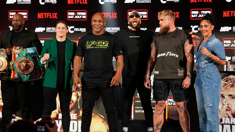Katie Taylor, Mike Tyson, Jake Paul and Amanda Serrano, from left, pose for photos during a news conference promoting their upcoming boxing bouts, Thursday, May 16, 2024, in Arlington, Texas. The fights are scheduled for July 20. (AP Photo/Sam Hodde)