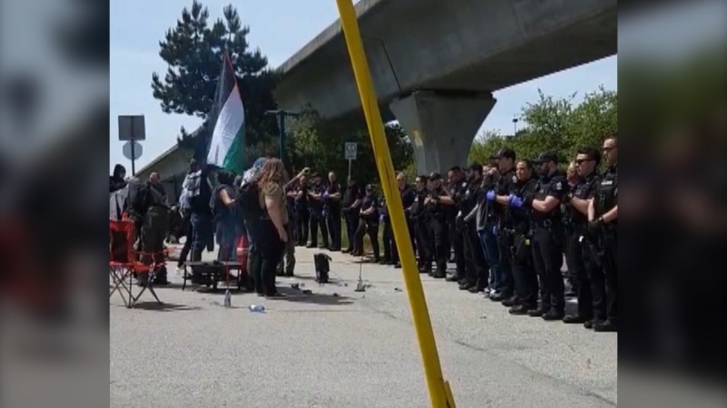 Vancouver police line up opposite pro-Palestinian protesters blocking road and rail traffic in East Vancouver on Friday, May 31, 2024. (X.com / @AaronPettman)