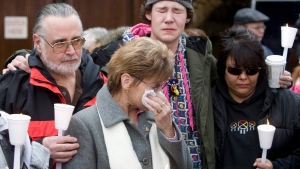 In this file photo, Rick Frey, left, father of victim Marnie Frey, and stepmother Lynn, centre, along with other unidentified family members take part in a prayer circle outside the B.C. Supreme Court in New Westminster, B.C. Sunday, December 9, 2007, after Robert Pickton was found guilty on six counts of second-degree murder in the deaths of six women from Vancouver's notorious Downtown Eastside neighbourhood. (THE CANADIAN PRESS/Jonathan Hayward)
