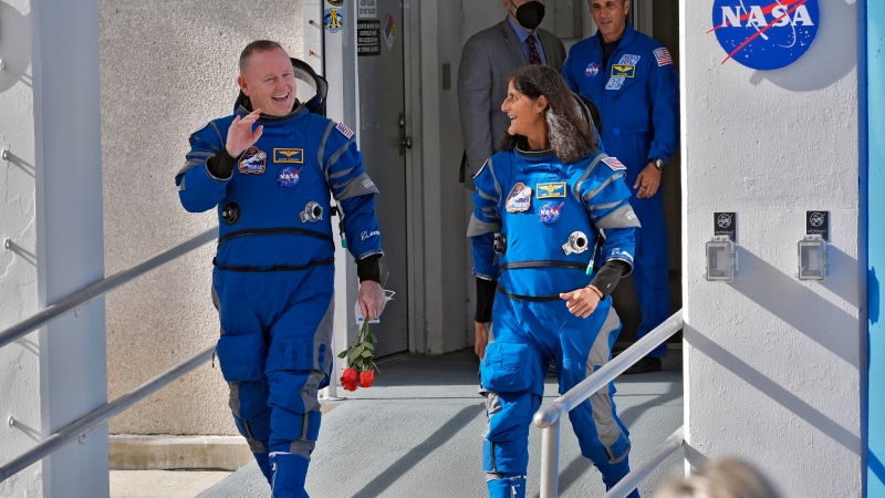 NASA astronauts Butch Wilmore, left, and Suni Williams share a laugh as they leave the operations and checkout building for a trip to launch pad at Space Launch Complex 41 Saturday, June 1, 2024, in Cape Canaveral, Fla. (AP Photo/John Raoux)
