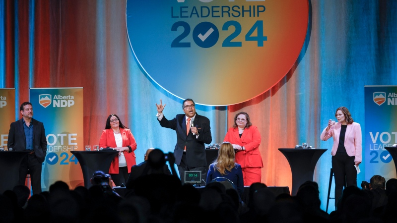 Alberta NDP leadership candidate Naheed Nenshi, centre, makes an closing statement as fellow candidates, left to right, Gil McGowan, Jodi Calahoo Stonehouse, Sarah Hoffman, and Kathleen Ganley look on during a leadership debate in Calgary on May 11, 2024. (Jeff McIntosh)