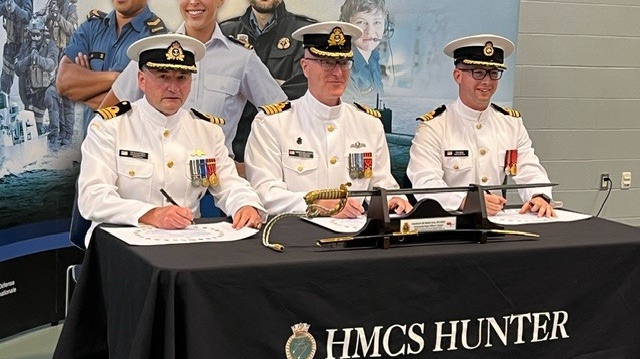 Outgoing Commanding Officer Richard Hillier, Captain Geoffrey Hamilton and incoming Commanding Officer Chris Elliott are seen at a swearing-in ceremony for Elliott on June 1, 2024. (Chris Campbell/CTV News Windsor)