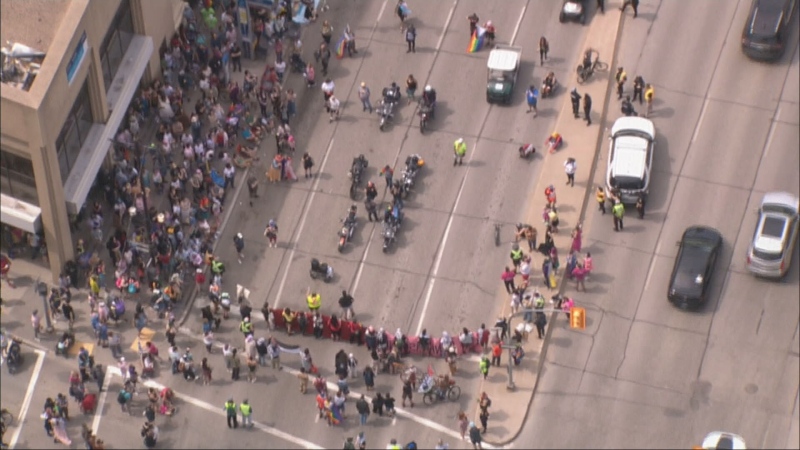 An aerial photo shows a blockade stopping the Winnipeg Pride Parade at Portage Avenue and Fort Street on June 2, 2024. (CTV News Winnipeg)