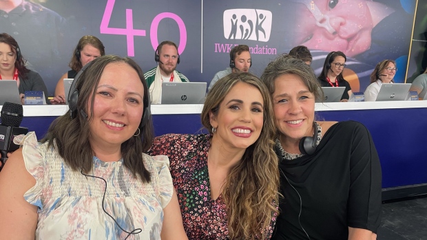 CTV's Ana Almeida takes a photo with two people working the phones at the IWK Telethon for Children on Sunday, June 2, 2024. (CTV/Roxanne Robinson) 