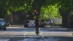 A cyclist cruises down the street in Montreal. More and more tickets are being given out to cyclists as riders continue to ride wearing headphones, through stop signs and without helmets when on e-bikes. 