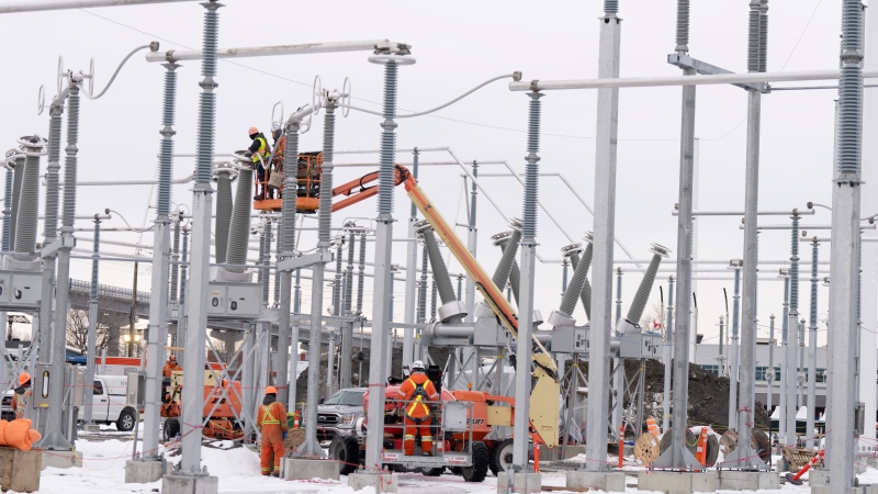 Hydro Quebec employees work on the construction site of a new substation in Montreal, Tuesday, Dec. 12, 2023. (Christinne Muschi, The Canadian Press)