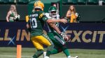 Saskatchewan Roughriders' Clint Ratkovich (25) scores a touchdown as Bethel-Thompson (10) chases during first half CFL pre-season action in Edmonton, Alta., on Saturday May 25, 2024. (THE CANADIAN PRESS/Jason Franson)