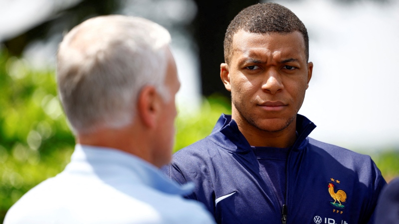 French soccer player Kylian Mbappe, right, listening to head coach Didier Deschamps at the national soccer team training center in Clairefontaine, west of Paris, Monday, June 3, 2024 ahead of the UEFA Euro 2024. (Sarah Meyssonnier / Pool Photo via AP)