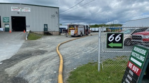 Halifax Regional Fire crews are seen at Burnside Recycling on Simmonds Drive in Dartmouth, N.S., on June 3, 2024. 
