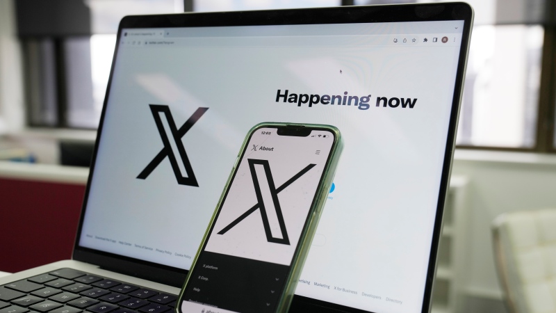 FILE - The opening page of X is displayed on a computer and phone, Oct. 16, 2023, in Sydney. (Rick Rycroft / AP Photo, File)