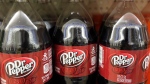 This Thursday, April 28, 2016, file photo shows bottles of Dr. Pepper on a store shelf at Quality Cash Market in Concord, N.H. (AP Photo/Jim Cole, File)