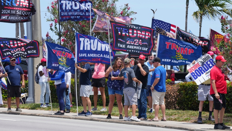 Supporters of U.S. President Donald Trump gather along Southern Boulevard in West Palm Beach, Fla., Sunday, June. 2, 2024. (AP Photo/Jim Rassol)