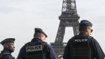 French prosecutors said three men have been placed under investigation on suspicion of perpetrating 'psychological violence' after placing five coffins at the foot of the Eiffel Tower. (Michael Euler/AP Photo)
