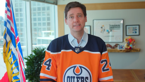 B.C. Premier David Eby wears an Edmonton Oilers jersey in a video posted to social media on Monday, June 3, after losing a bet to Alta. Premier Danielle Smith. 