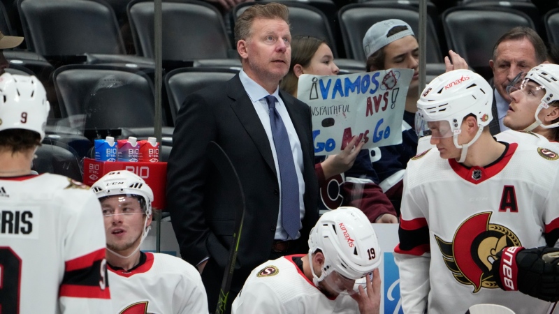 Ottawa Senators assistant coach Daniel Alfredsson stands behind players during the second period of the team's NHL hockey game against the Colorado Avalanche on Thursday, Dec. 21, 2023, in Denver. (AP Photo/David Zalubowski)
