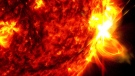 This image provided by NASA's Solar Dynamics Observatory shows a solar flare, right, on May 14, 2024, captured in the extreme ultraviolet light portion of the spectrum colorized in red and yellow. (NASA/SDO via AP)