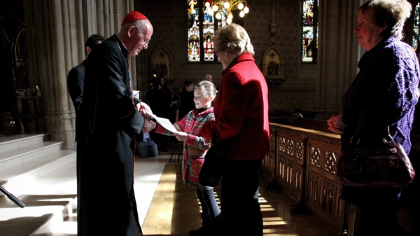 Primate of All Ireland Cardinal Sean Brady hands out a letter from the Pope to worshippers, at St Patrick's Cathedral in Armagh, Northern Ireland, on Saturday, March, 20, 2010. (AP / Peter Morrison)