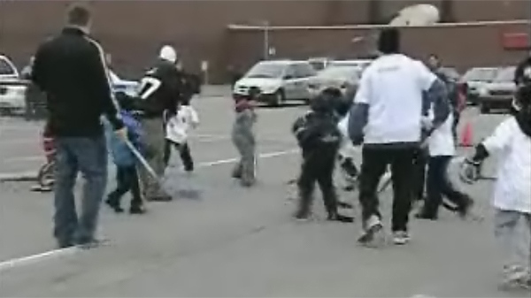 Children and adults play street hockey outside the Dollard-Des-Ormeaux Civic Centre as a form of protest on Monday, March 22, 2010.