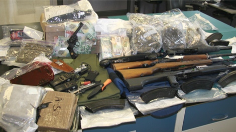 Police show off various items, including drugs, weapons and cash, that were seized during a drug trafficking bust in the Ottawa area.