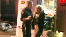 A Toronto paramedic treats a patient at the scene outside a local strip club where a fight broke out on March 24, 2010.