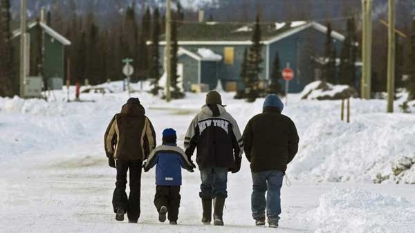 Residents walk in the northern Labrador community of Natuashish, N.L. on Thursday, Dec. 6, 2007. (Andrew Vaughan /  THE CANADIAN PRESS)