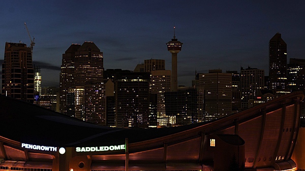 Downtown buildings go mostly dark to celebrate Earth Hour but lights stay on at the Saddledome, foreground, because of an event in Calgary, Alberta on Saturday March 27, 2010. (Larry MacDougal / THE CANADIAN PRESS)