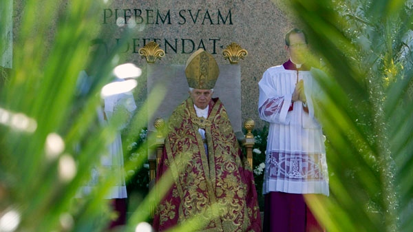 Pope Benedict XVI is framed by palm tree branches during an open-air Palm Sunday mass in St. Peter's square at the Vatican, Sunday, March 28, 2010. (AP / Andrew Medichini)