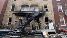 Firefighters at the scene of a fatal fire that left four dead in Montreal on Sunday, March 28, 2010. (THE CANADIAN PRESS/Graham Hughes)
