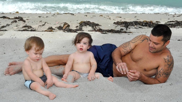 In this August 2009 family photo provided courtesy of Ricky Martin, singer and actor Ricky Martin is shown on the beach with his twin sons Matteo, left, and Valentino, in Miami. (AP Photo / Courtesy of Ricky Martin, Pablo Alfaro)