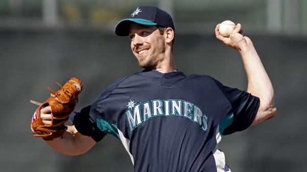 Seattle Mariners starting pitcher Cliff Lee throws a pitch during simulated game in a baseball spring training workout, Friday, March 5, 2010, in Peoria, Ariz. (AP Photo/Charlie Neibergall)