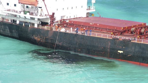 In this Monday, April 5, 2010 handout photo supplied by Queensland Maritime Safety, oil leaks from the Chinese-registered 230-metre-long bulk coal carrier Shen Neng 1st that rests aground on Douglas Shoals off the coast of Rockhampton, Australia. 