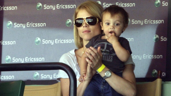 Elin Nordegren, the wife of Tiger Woods, sits with her son Charlie during a semifinal match between Rafael Nadal and Andy Roddick at the Sony Ericsson Open tennis tournament in Key Biscayne, Fla. Friday, April 2, 2010. (AP / Lynne Sladky)