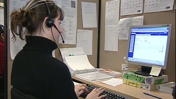 A woman takes a call at a call centre, in an undated image taken from video.