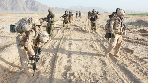A joint Canadian and Afghan patrol take a breather at the start of a clearance operation in Adamzai, southwest of Kandahar City. on Friday, March 26, 2010. (THE CANADIAN PRESS/Murray Brewster)