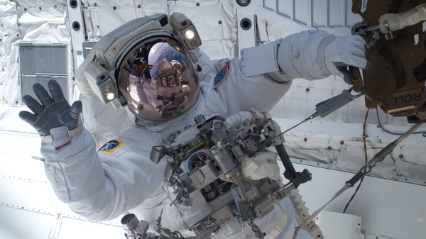 In this image provided by NASA, astronaut Clayton Anderson waves during the mission's first spacewalk Friday April 9, 2010. (AP / NASA)