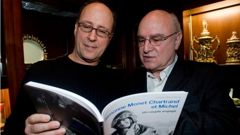 Dominique, left, and Alain Chartrand browse through the pages of 'Simonne Monet Chartrand et Michel', a book about the life of their father Michel Chartrand, at the launch of the book in Montreal Tuesday, March, 2, 2010.