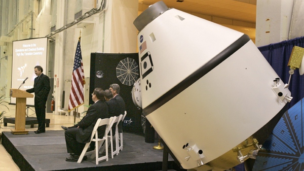 A model of the Orion Crew Space Exploration Vehicle, right, the next-generation human spacecraft, is displayed during a ceremony at the Operations and Checkout building at the Kennedy Space Center in Cape Canaveral , Fla., in a Tuesday, Jan. 30, 2007 file photo. (AP Photo/John Raoux, File)
