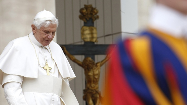 Pope Benedict XVI walks away as a Swiss guard stands in foreground, following his weekly general audience, in St. Peter's Square at the Vatican, Wednesday, April 14, 2010. (AP Photo/Pier Paolo Cito)