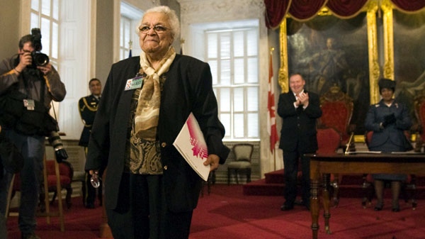 Wanda Robson heads to her seat as Premier Darrell Dexter and Lt.-Gov. Mayann Francis, right, look on at a ceremony at the legislature in Halifax on Thursday, April 15, 2010. The government of Nova Scotia apologized and granted a special pardon to Robson's sister, the late Viola Desmond, a black woman jailed in 1946 for sitting in a whites-only section of a segregated movie theatre. (THE CANADIAN PRESS/Andrew Vaughan)