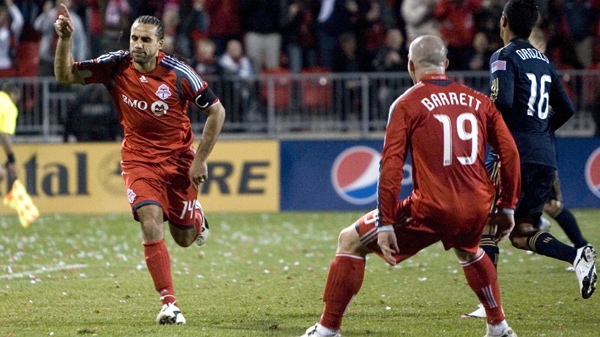 Toronto FC's Dwayne DeRosario (left) celebrates scoring his team's second goal from the penalty spot as team mate Chad Barrett (centre) and Philadelphia Union's Mike Orozco look on during second half MLS action in Toronto on Thursday April 15, 2010. (Chris Young / THE CANADIAN PRESS)