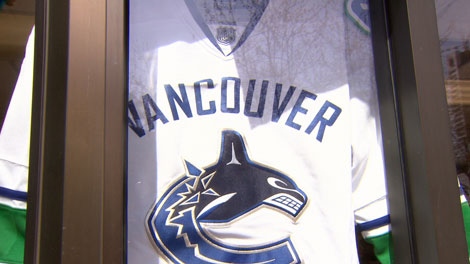 Canucks jersey hangs in a storefront.